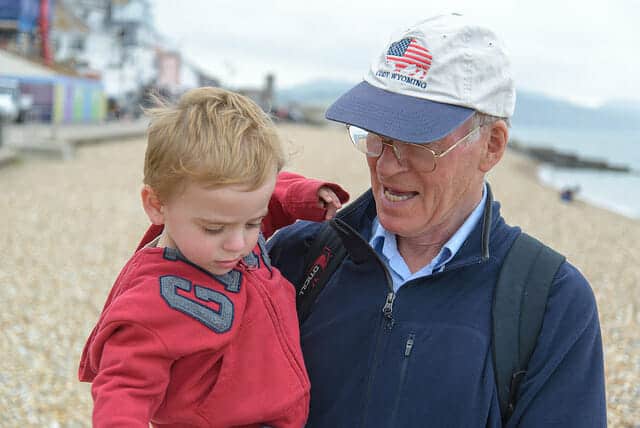 Grandfather and child on beach