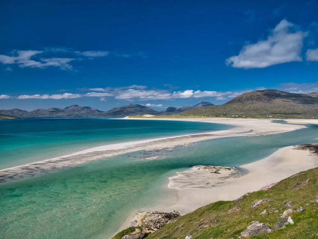 The white sands and turquoise waters of the pristine Luskentyre Bay in the Outer Hebrides. Taken on a sunny day in summer.